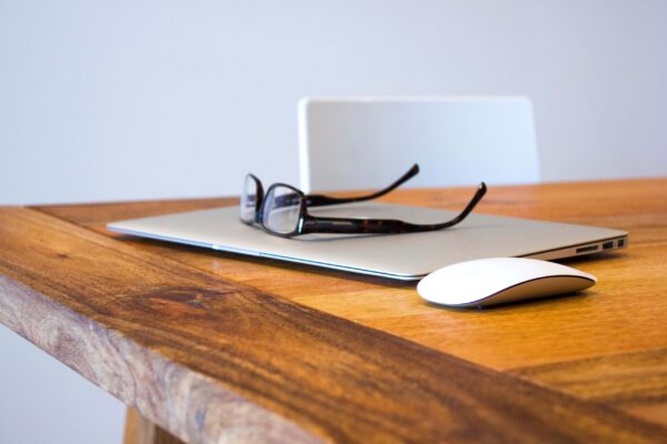 Glasses Ontop of Macbook With Magic Mouse