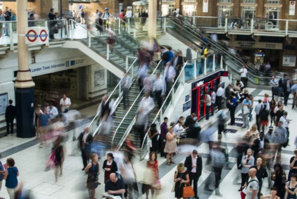 People Walking Down Stairs in Train Station